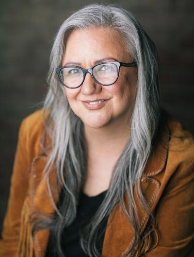 Dr. Cheryl Bear  brown blazer and black background